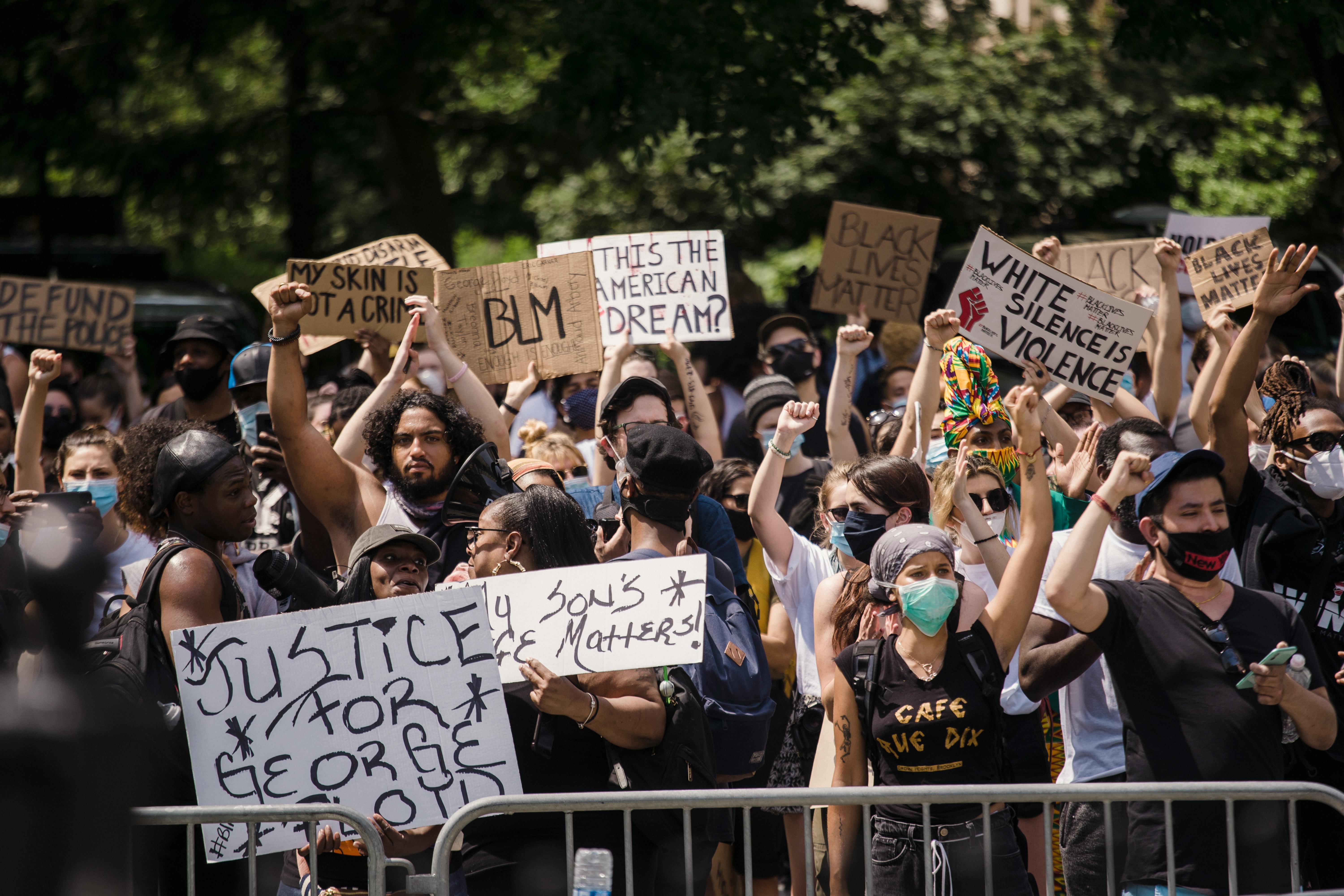 crowd of protesters holding signs