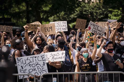 Free Protesters rally for justice and equality, displaying powerful signs in a city street. Stock Photo