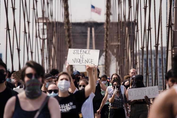 Crowd Of Protesters Holding Signs