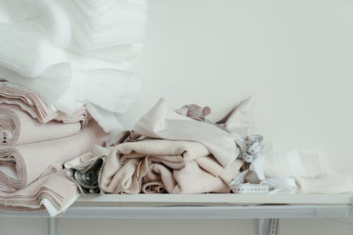 Baby Lying on Bed Covered With White Blanket