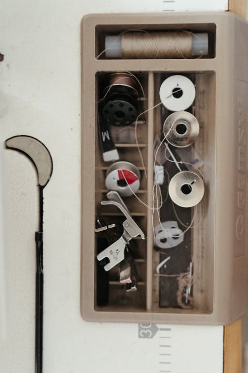 White and Black Corded Headphones on Brown Wooden Shelf