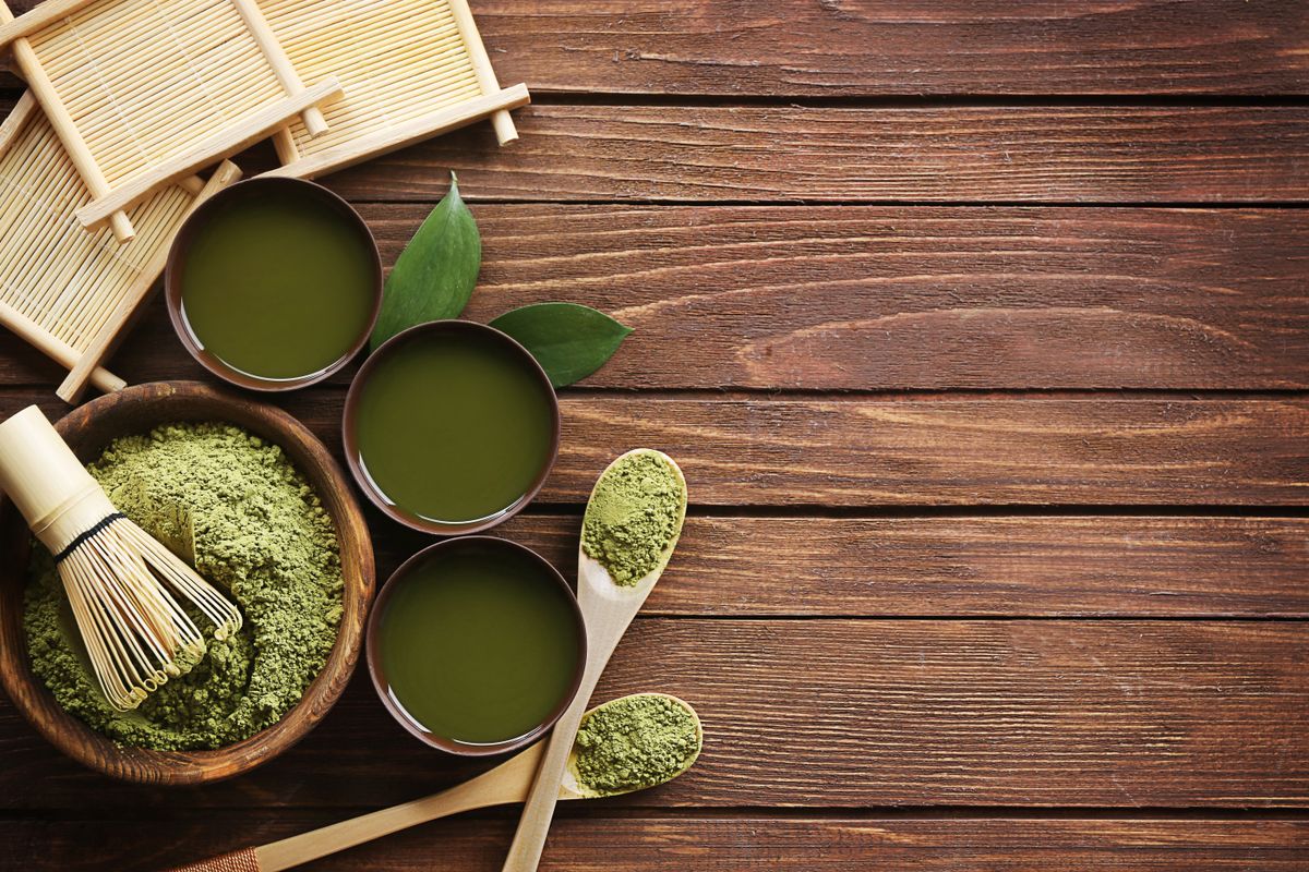 Matcha tea bowls and whisk on dark wood