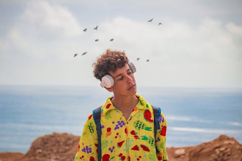 Free Curly Haired Man Wearing Headphones Stock Photo