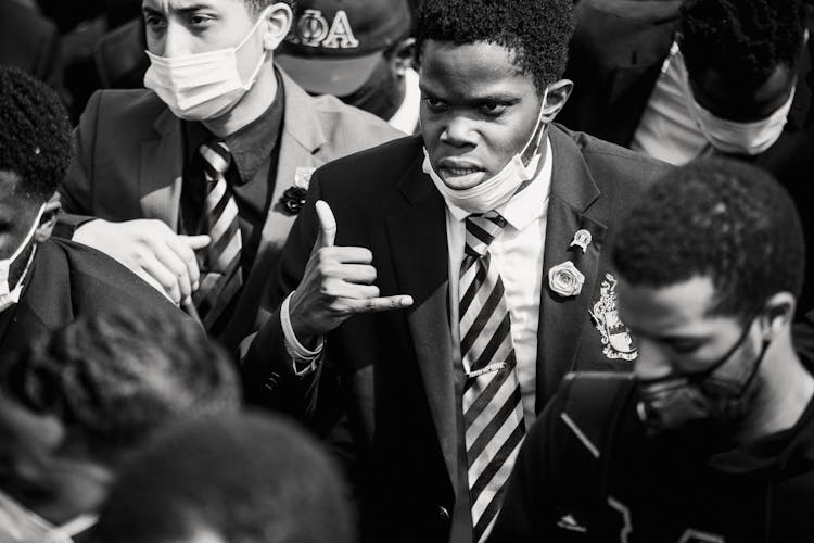 Man In A Crowd Making A Hand Gesture