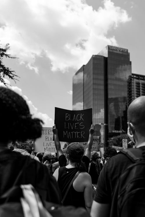 A Grayscale Photo of People Protesting on the Street