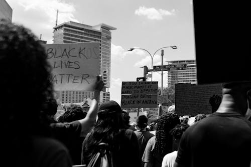 Grayscale Photo of People Protesting on Street