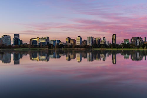 City Skyline Across Body of Water during Sunset