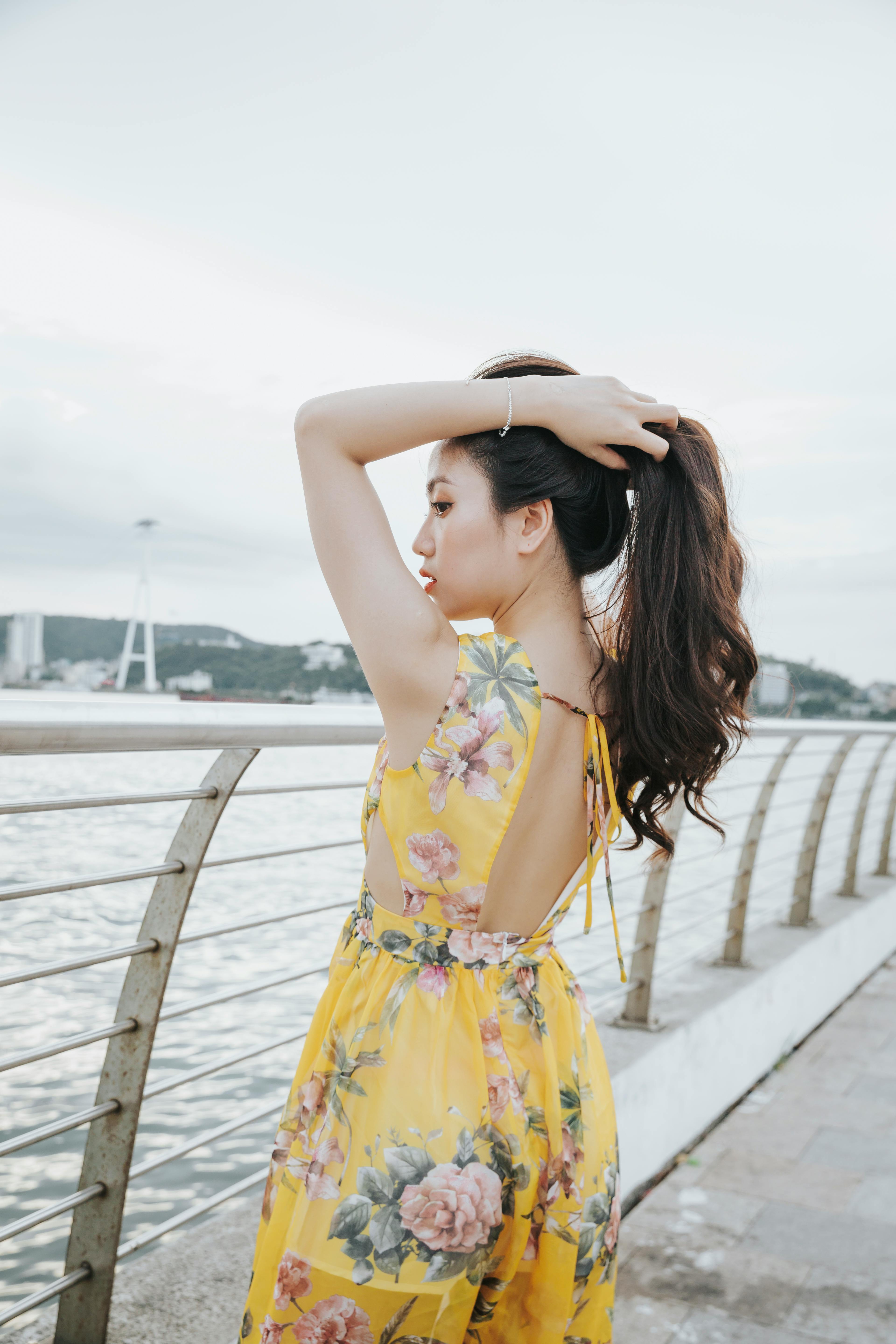 Calm redhead woman sitting on background · Free Stock Photo