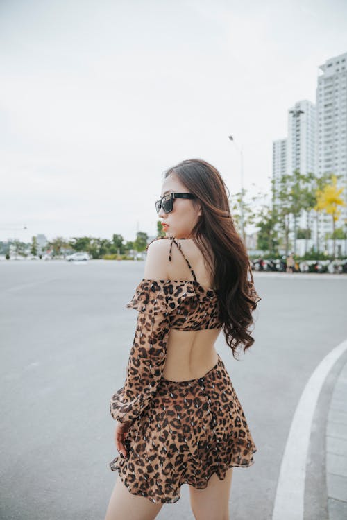 Stylish Asian woman standing on street