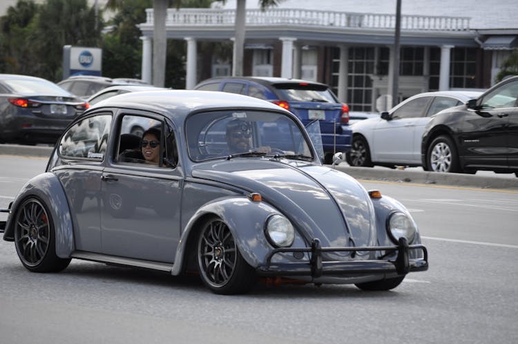 A Couple Riding A Vintage Car