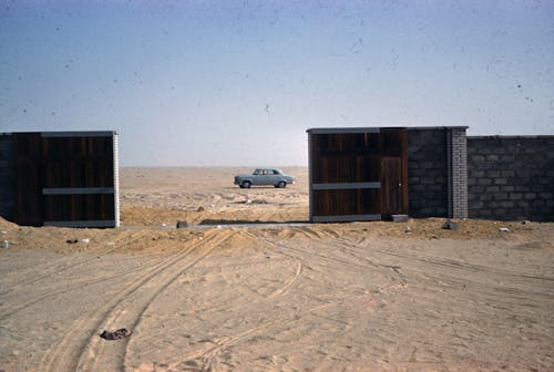 Car behind Gate on Desert