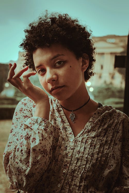 Dreamy ethnic woman with Afro hairstyle in town