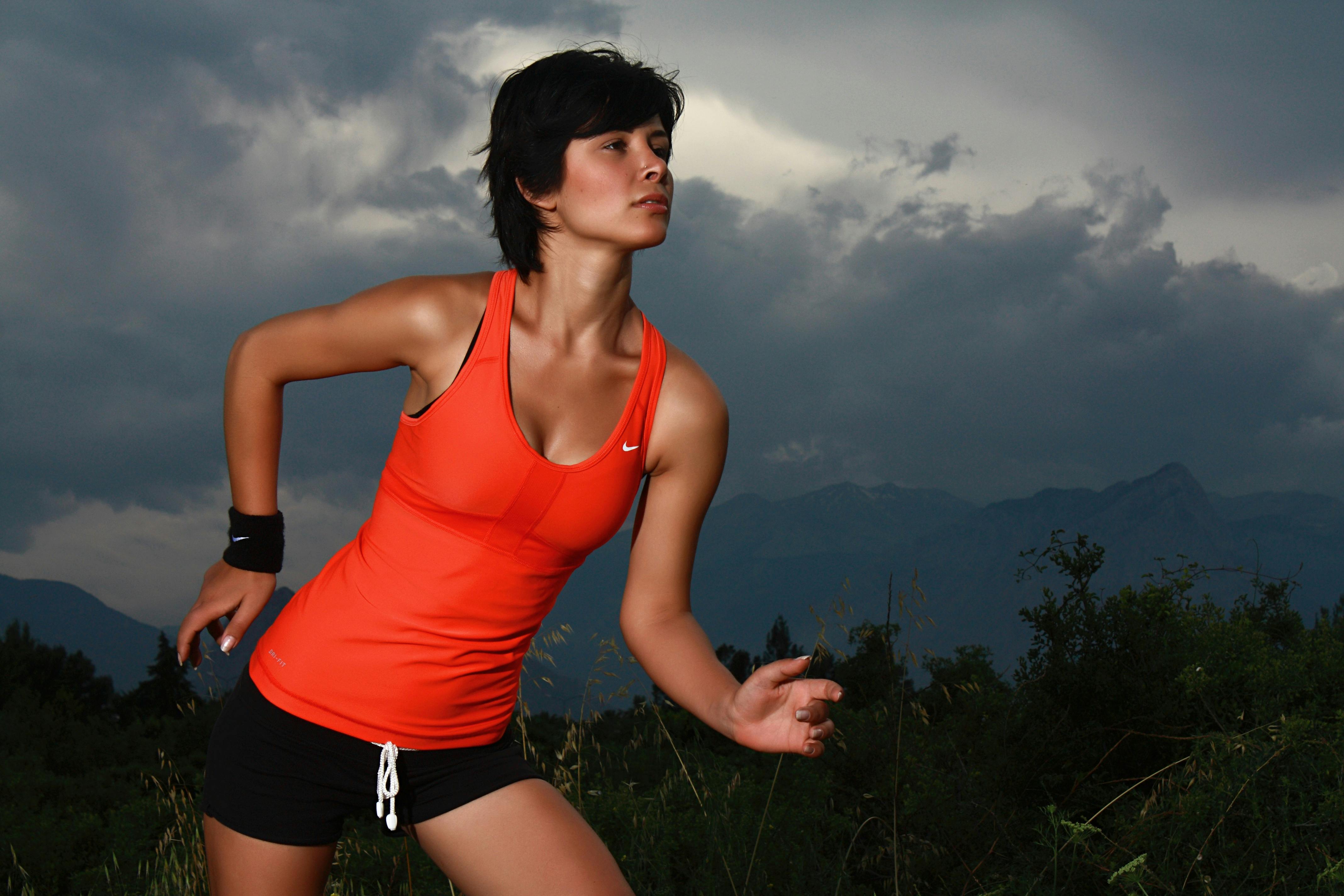 Woman in Sports Bra and Leggings Standing by the Wall 