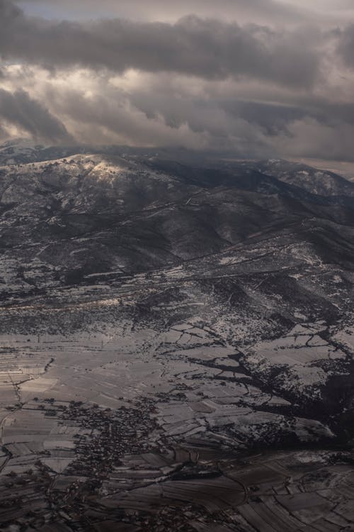 Rough mountain with dry surface under cloudy sky