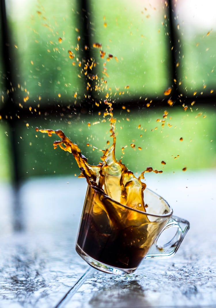 Glass Cup With Splash Of Coffee In Air