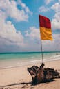 Flag on sandy beach near sea
