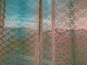 Apartment window with white curtain