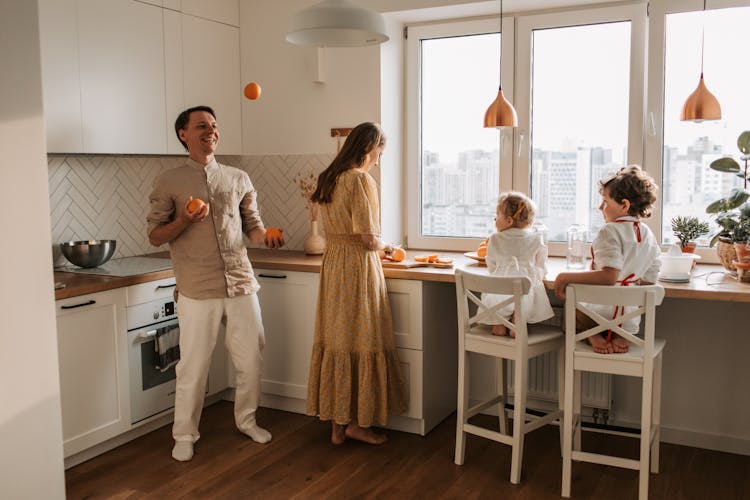 A Family Having Breakfast In The Kitchen Area