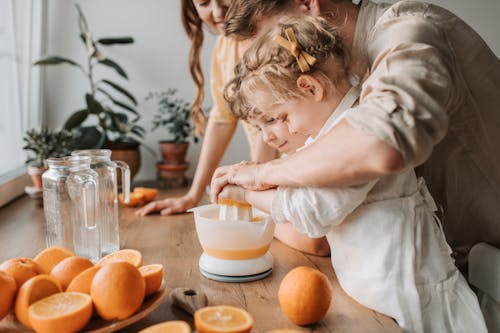 Free Kids Making Juice with their Parents Stock Photo