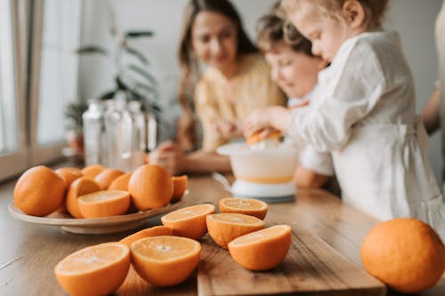 Kids Making Juice with Sliced Orange