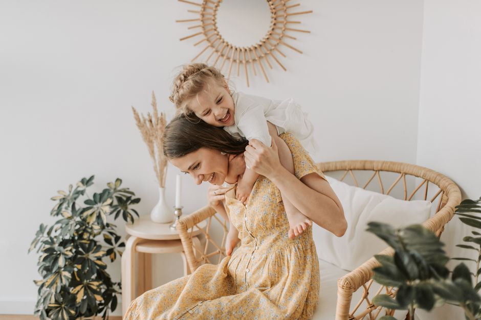Happy mother and daughter bonding at home, showcasing love and togetherness.