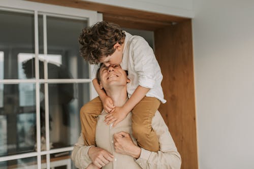 Free Man Carrying his Son on his Shoulders Stock Photo