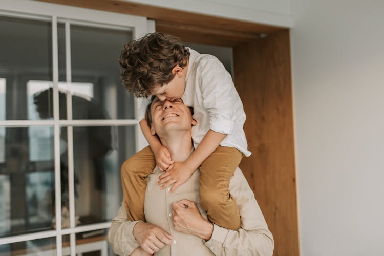 Man Carrying His Son On His Shoulders