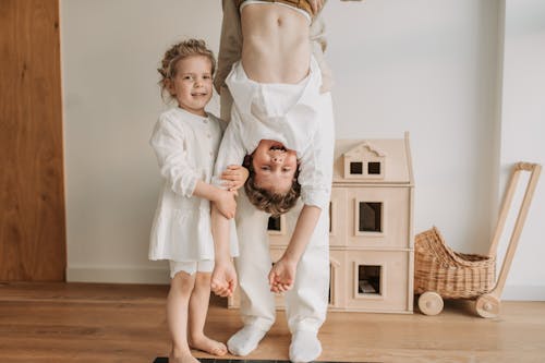 Photo of a Boy Hanging Beside His Sister