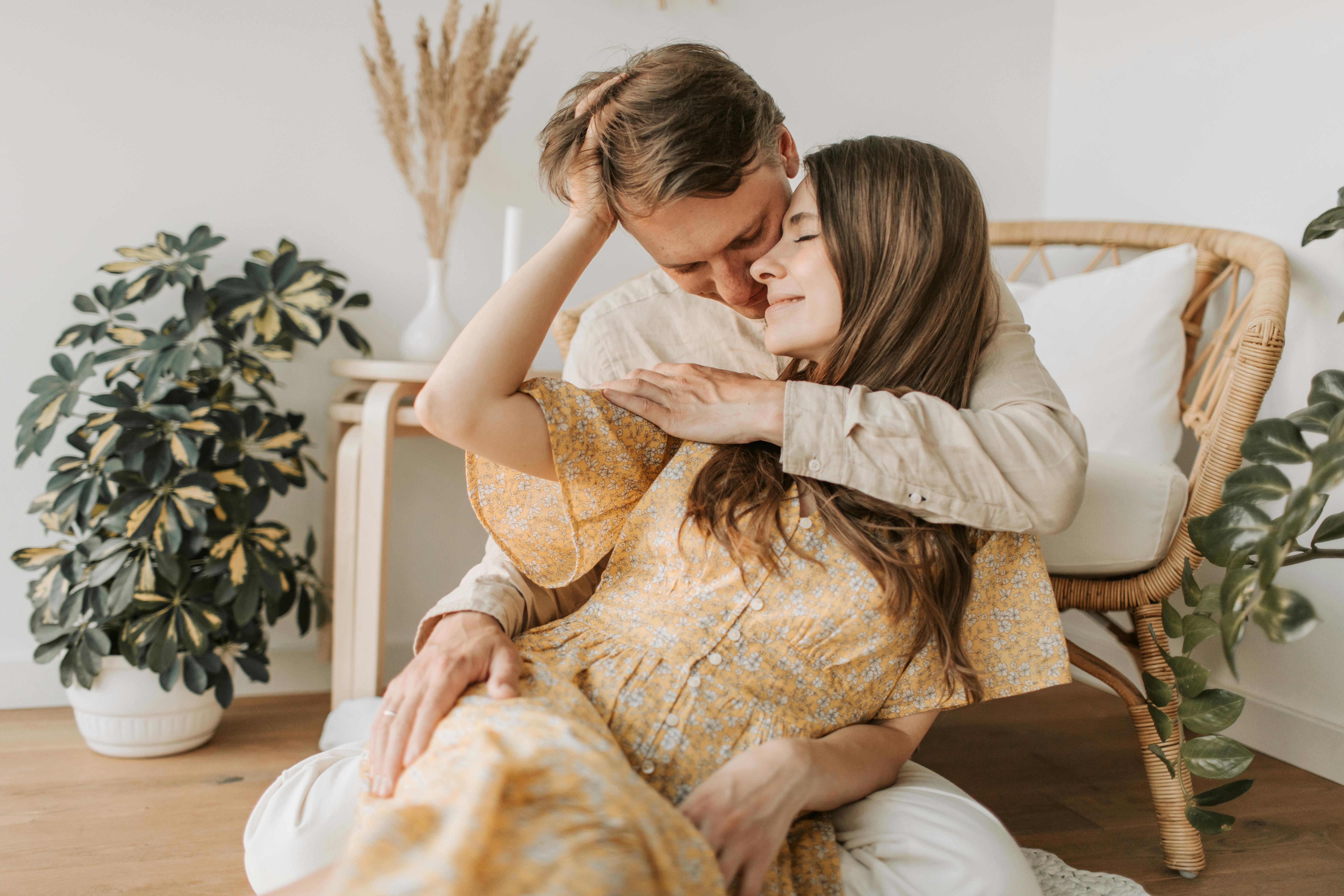 a man hugging the woman from behind