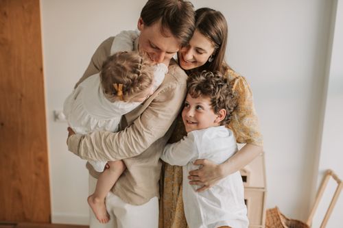 Free A heartwarming scene of a family hugging indoors, showcasing love and togetherness. Stock Photo