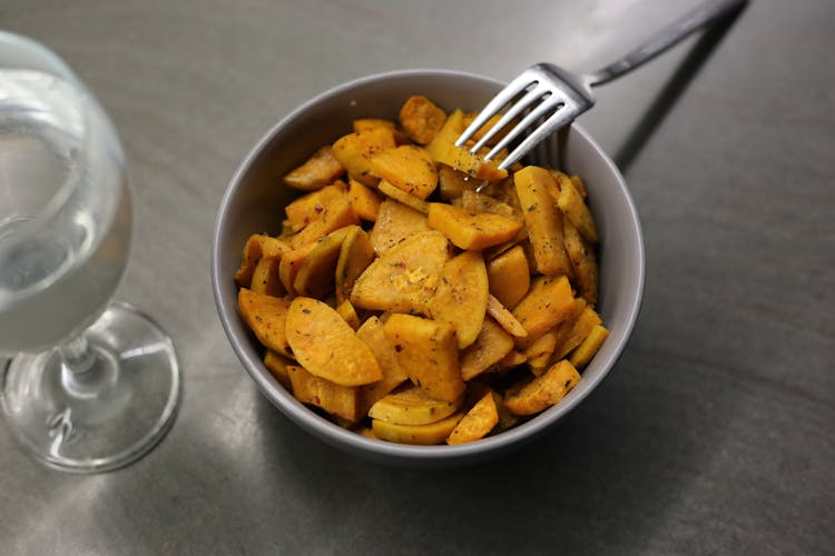 Homemade Fried Batata Served In Bowl With Fork