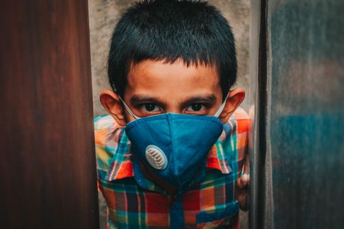 Free A young boy in Dhaka wearing a protective face mask during the Covid-19 pandemic. Stock Photo