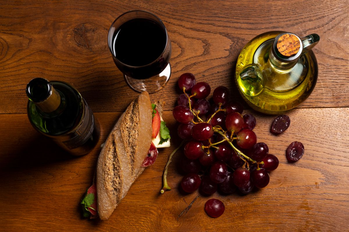 A sunlit southern French table with red wine and bread