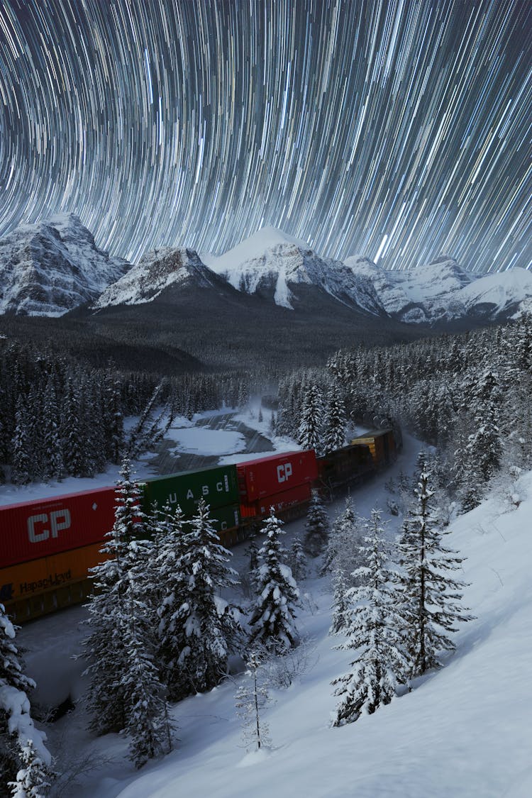 Starry Sky Over Mountainous Valley Covered With Snow