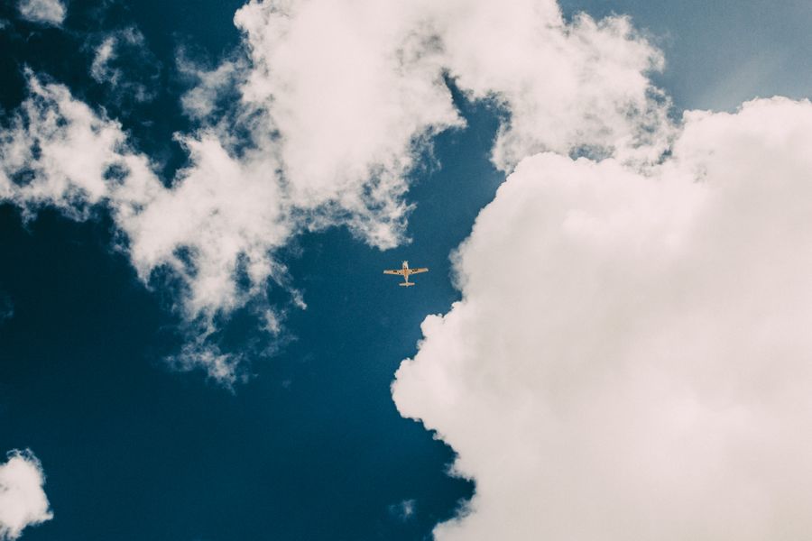 Airplane in a cloudy blue sky