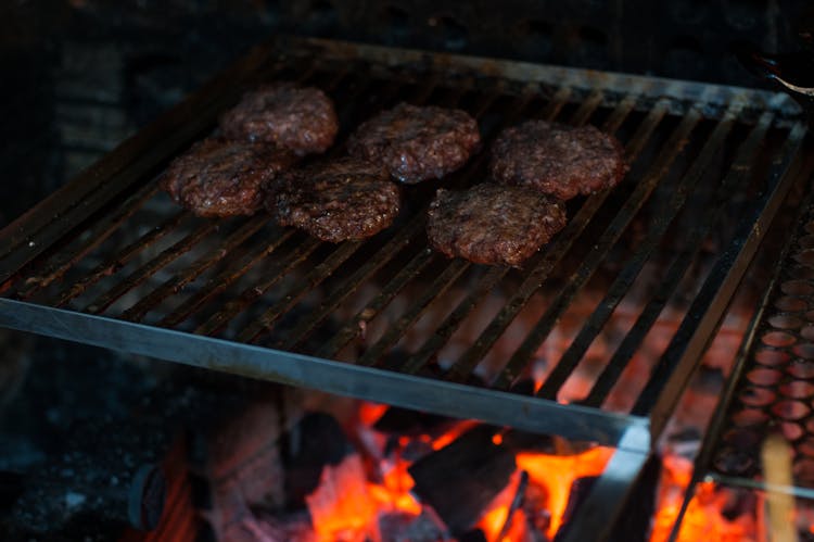 Appetizing Meat Patties On Grill Grid