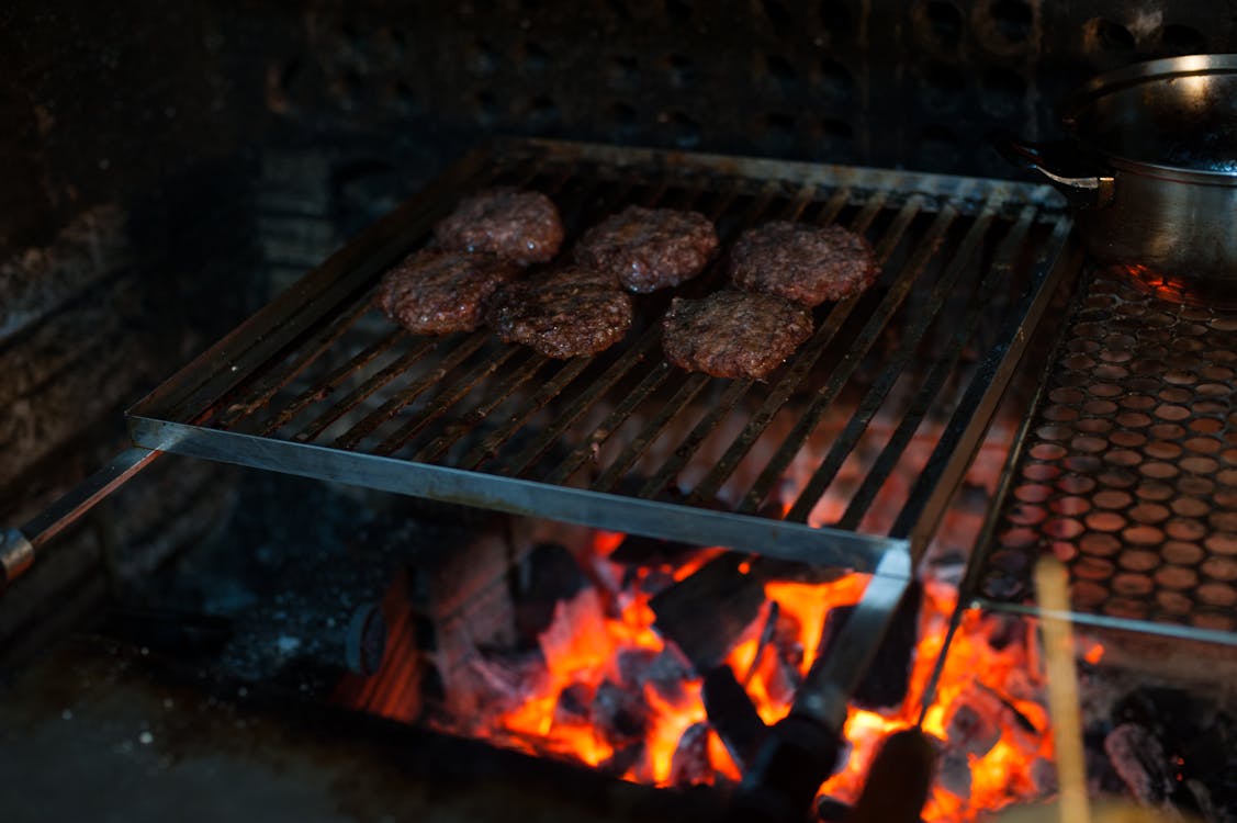 Free Grilling meat cutlets on barbecue grate Stock Photo