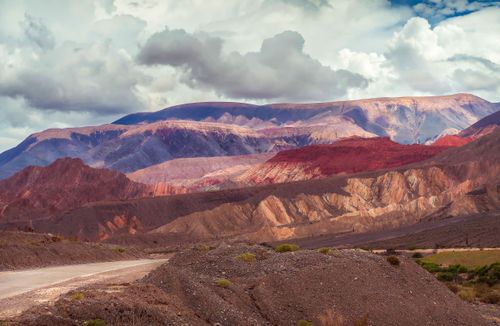 Free Spectacular landscape of rough sandy multicolored mountains located in volcanic terrain against cloudy sky Stock Photo