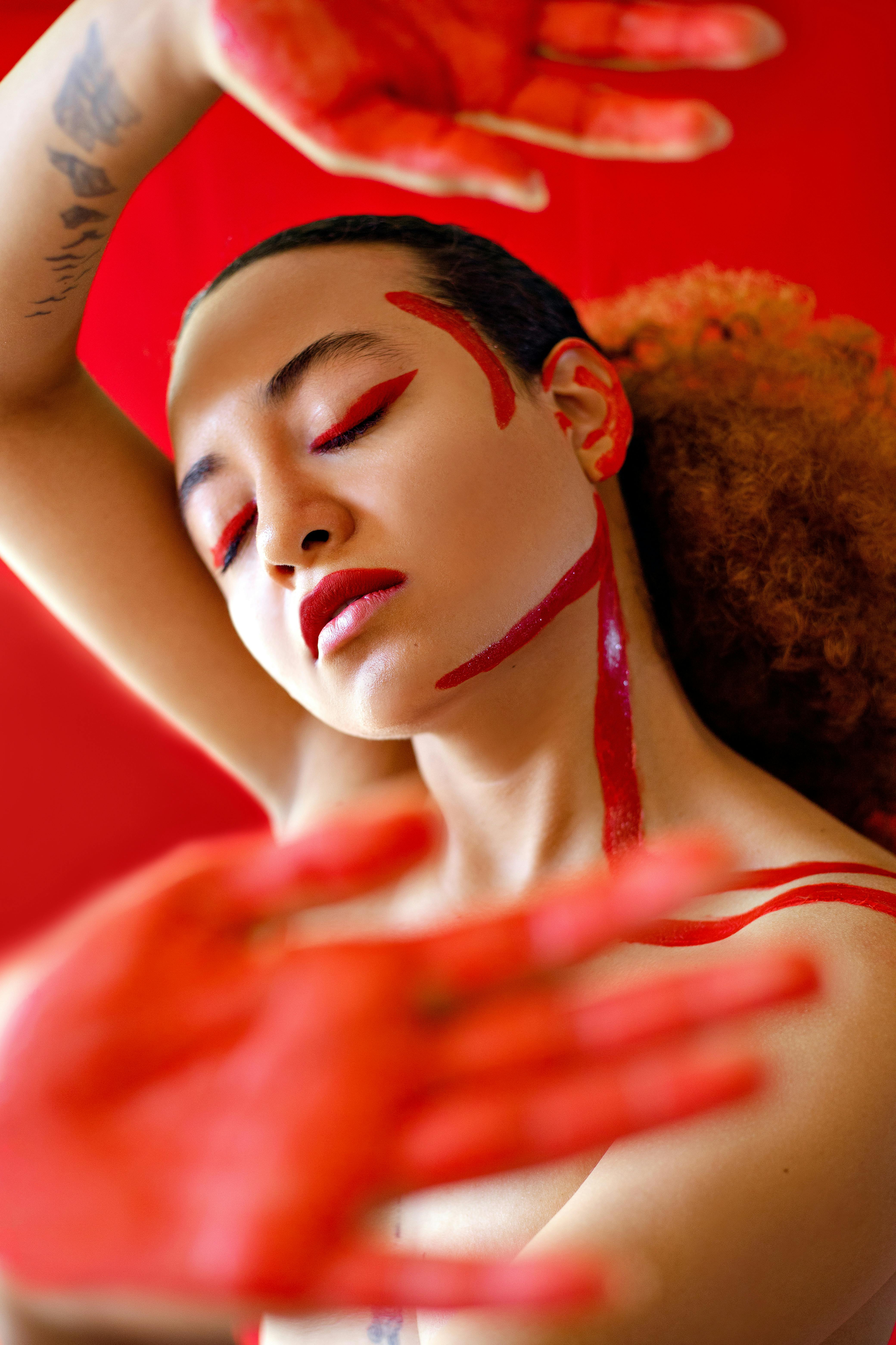 asian lady with red paint on face and body