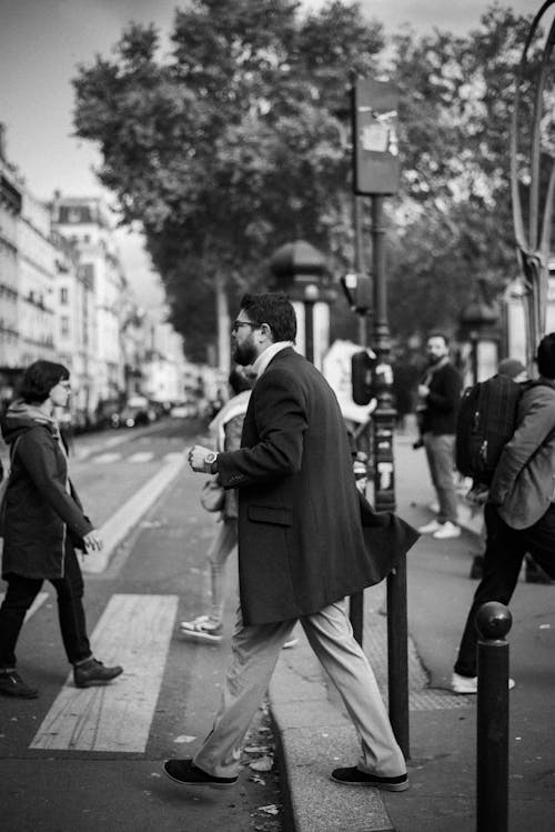 Black and White Photo of People Crossing the Street