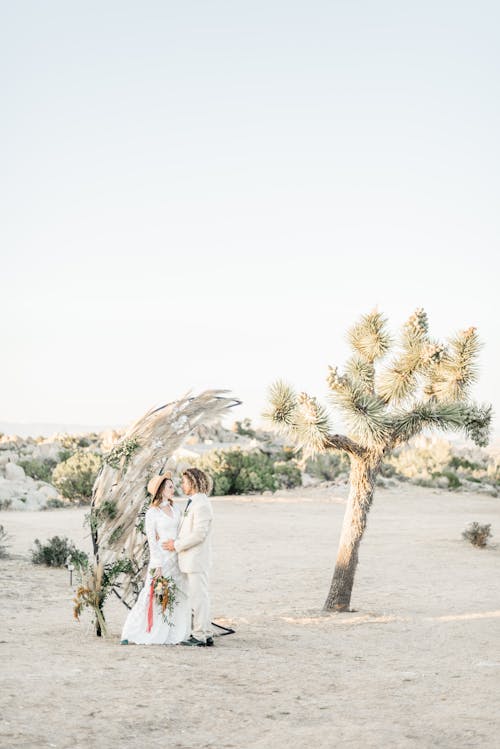 Woman in White Dress Standing Beside Tree