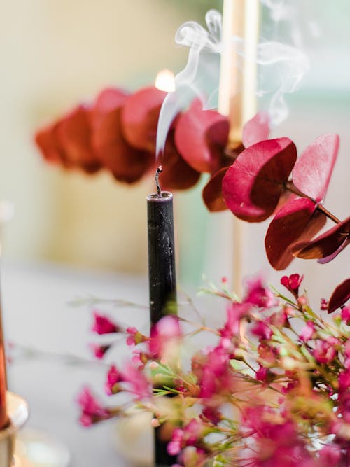 Black Candlestick Beside Pink Flowers