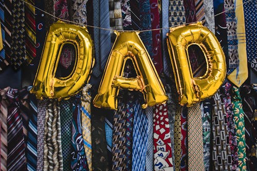 Free Golden Letter Balloons Forming the Word Dad Stock Photo
