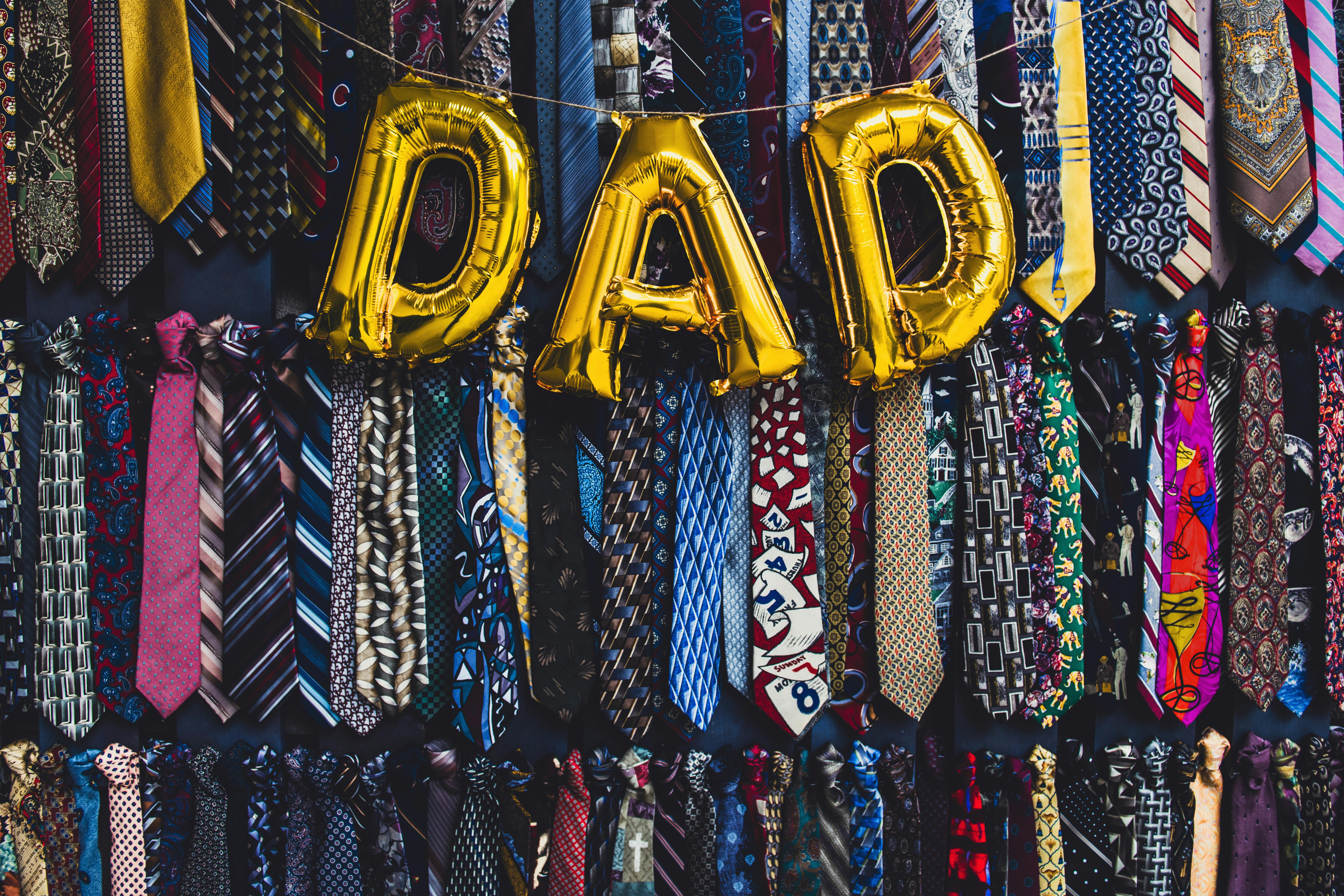 the word dad in golden balloon letters