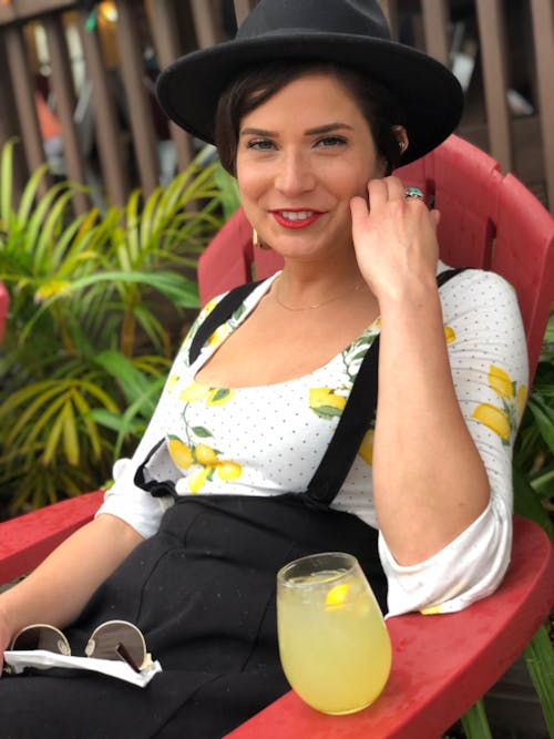 Cheerful woman resting and drinking lemonade