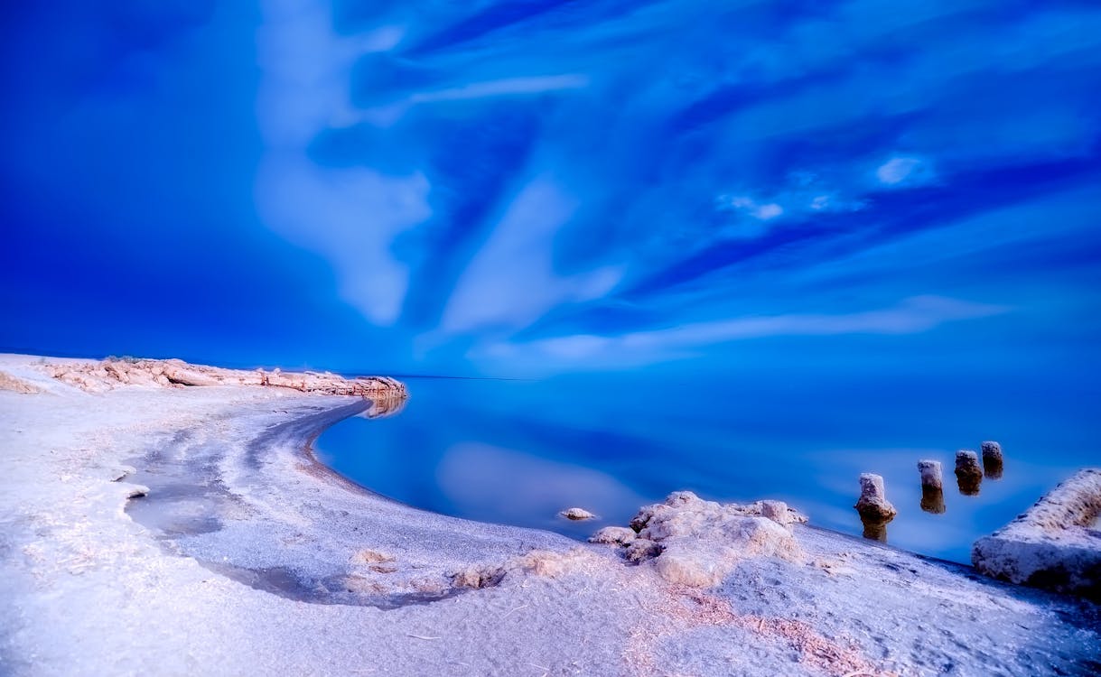 Shoreline Under Blue Sky