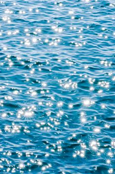 Captivating sunlit ripples on the ocean in Lisbon. Ideal for travel and nature themes.