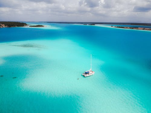 White Boat on Blue Sea Under Blue Sky