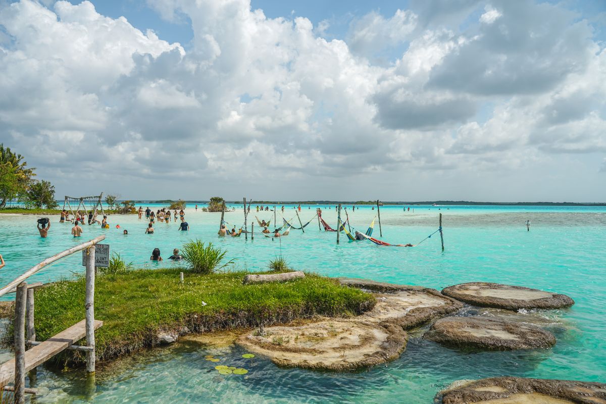 Relax by the turquoise waters of Bacalar Lagoon, a perfect tropical getaway with sandy shores and scenic views.