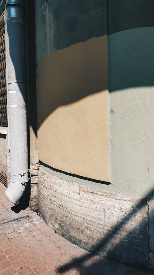 Free Textured urban wall with shadows on a sunny day in St. Petersburg, Russia. Stock Photo